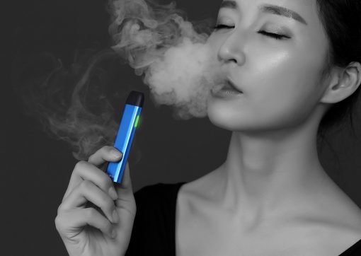 Women exhaling a vape cloud from blue KiwiPod buy vape shop auckland and online vape deliveries