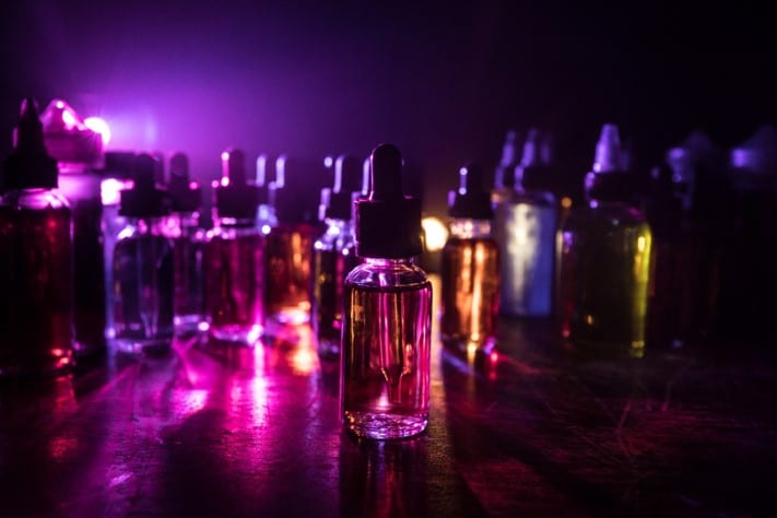 vape e-juice bottles in a dimly lit room