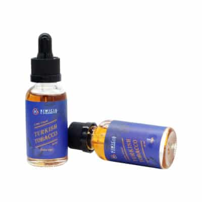 2 bottle of Turkish tobacco vape juice, 1 stand up right and 1 lying down